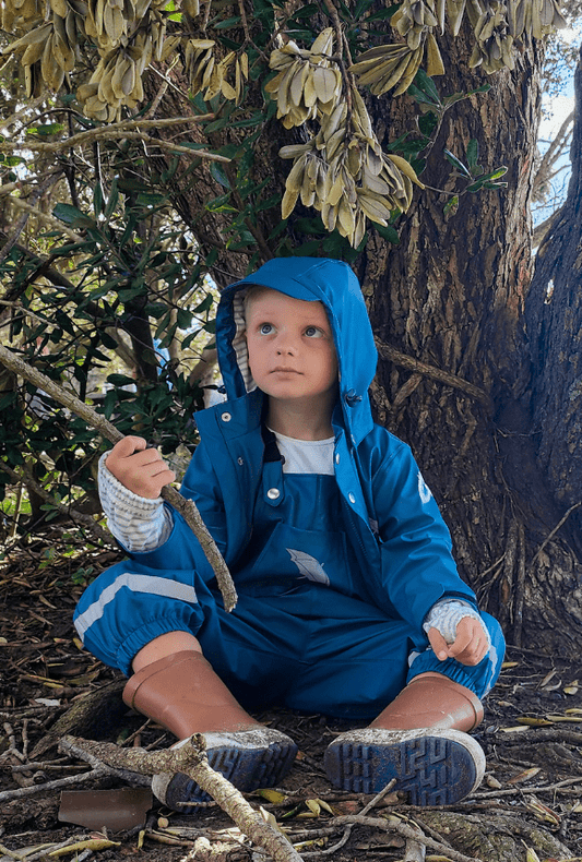 Toddler wearing Brolly Sheets New Wet Weather Gear while doing Rainy Weather Activities