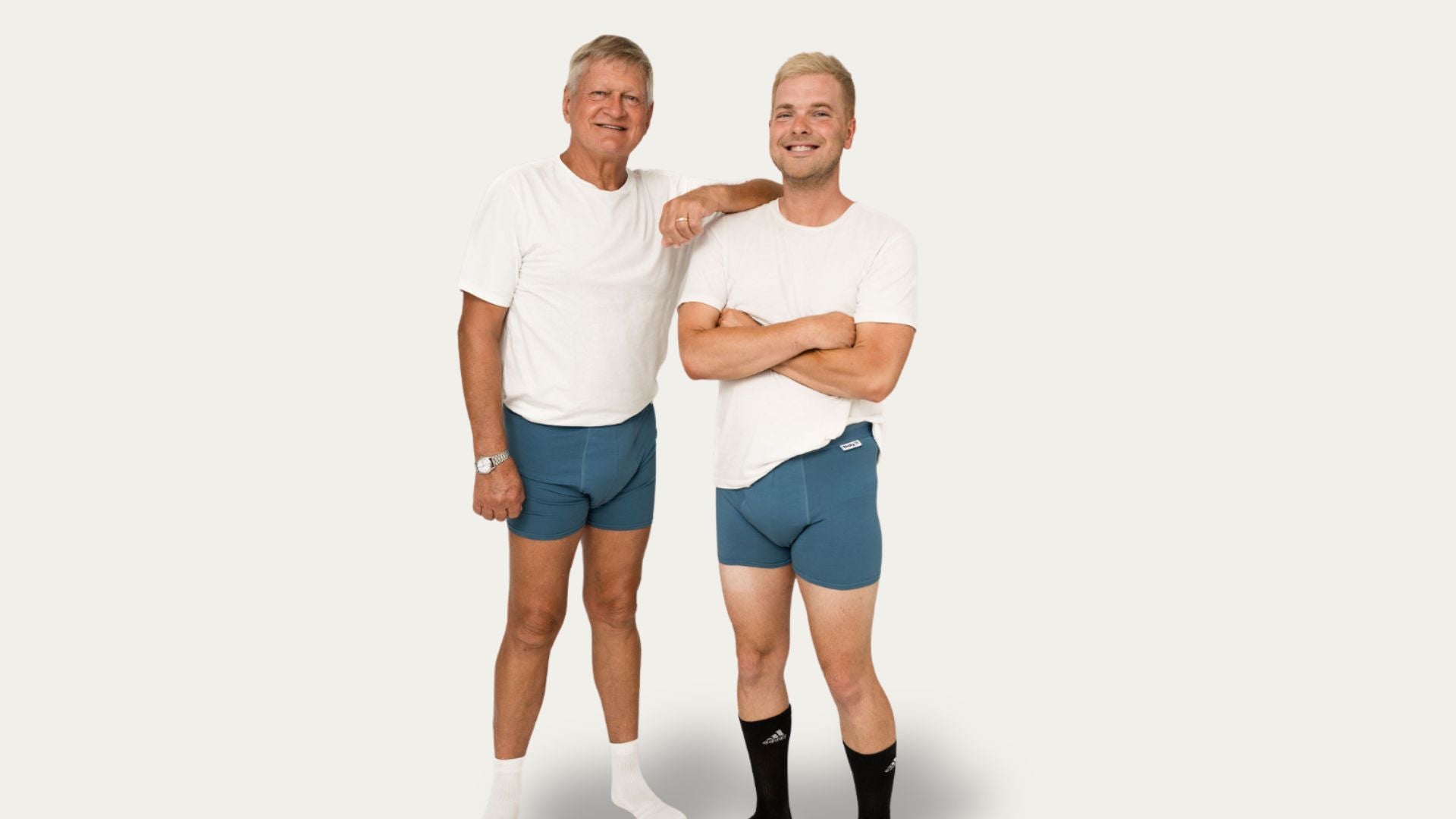 Two men wearing Brolly Sheets menās absorbent underwear, standing in a neutral setting to show fit, coverage, and discreet protection.