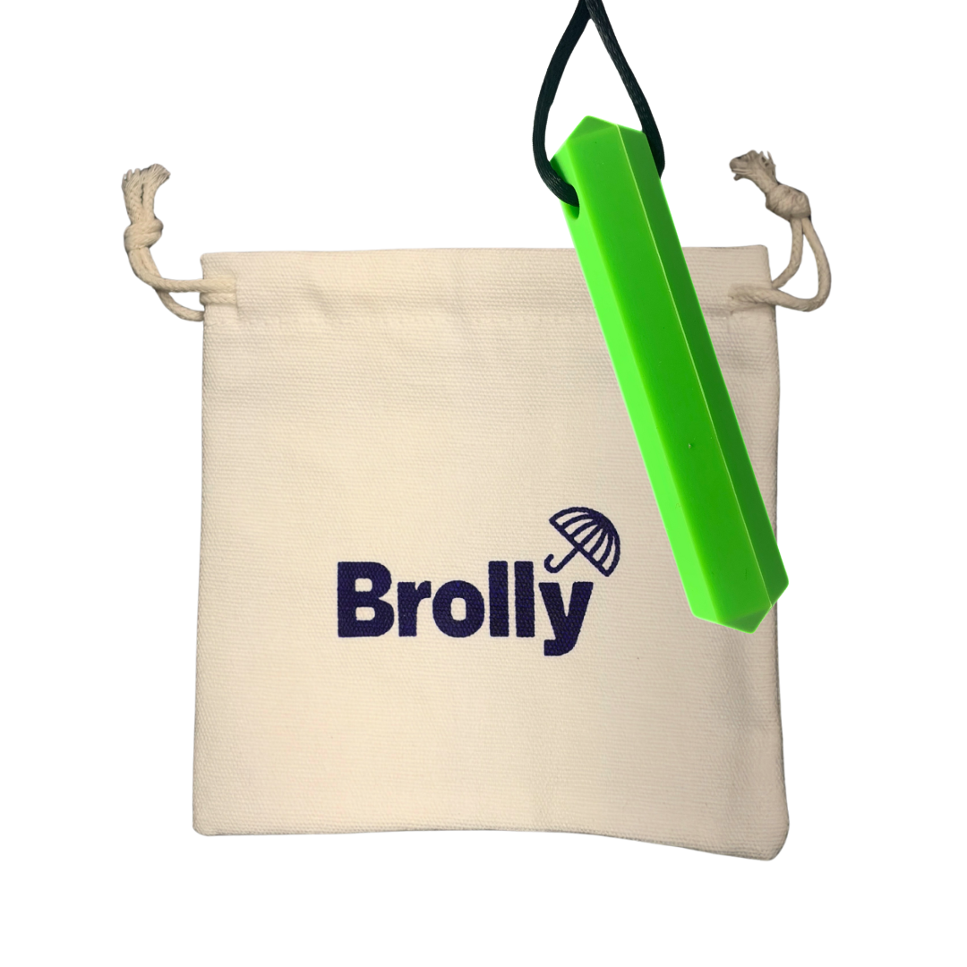 Beige drawstring pouch and Gem-shaped Brolly Sheet Chew Necklace on a black cord against a white background - Green