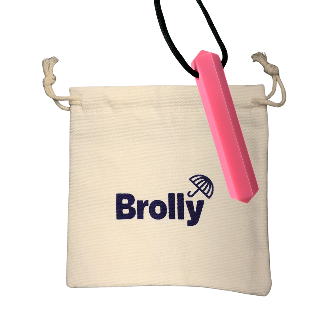 Beige drawstring pouch and Gem-shaped Brolly Sheet Chew Necklace on a black cord against a white background - Pink