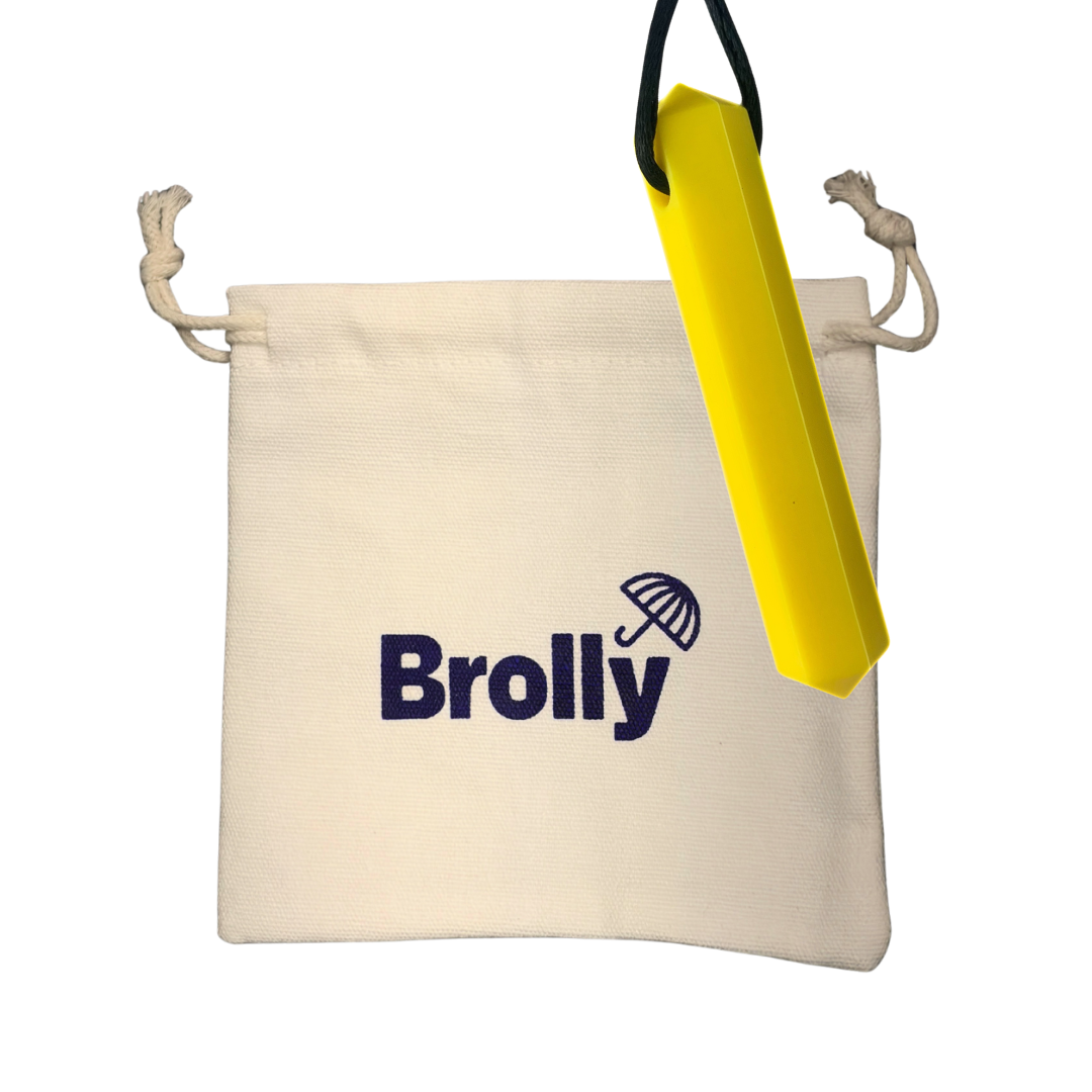 Beige drawstring pouch and Gem-shaped Brolly Sheet Chew Necklace on a black cord against a white background - Yellow