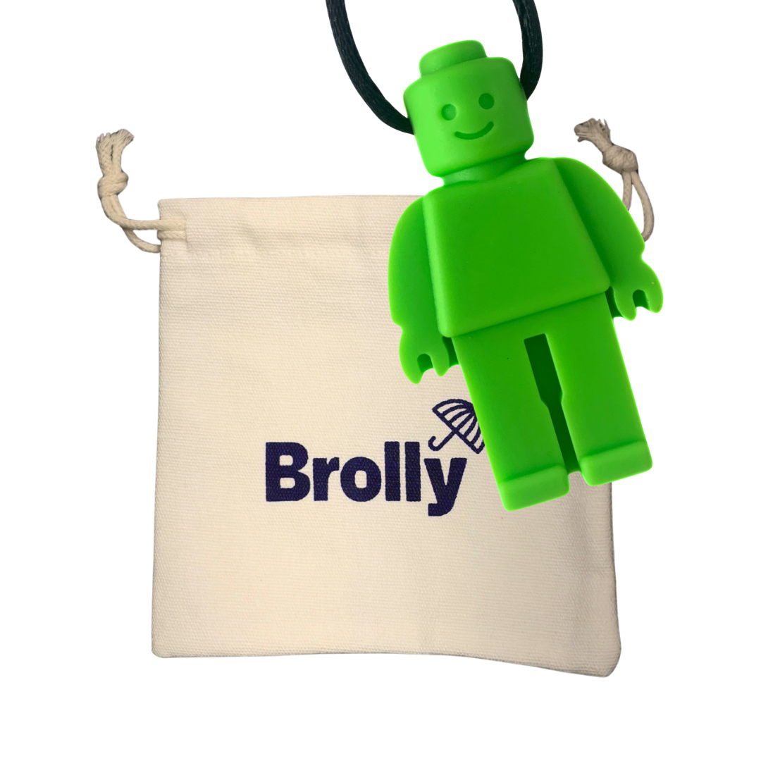 Beige drawstring pouch and Robot-shaped Brolly Sheet Chew Necklace on a black cord against a white background - Green