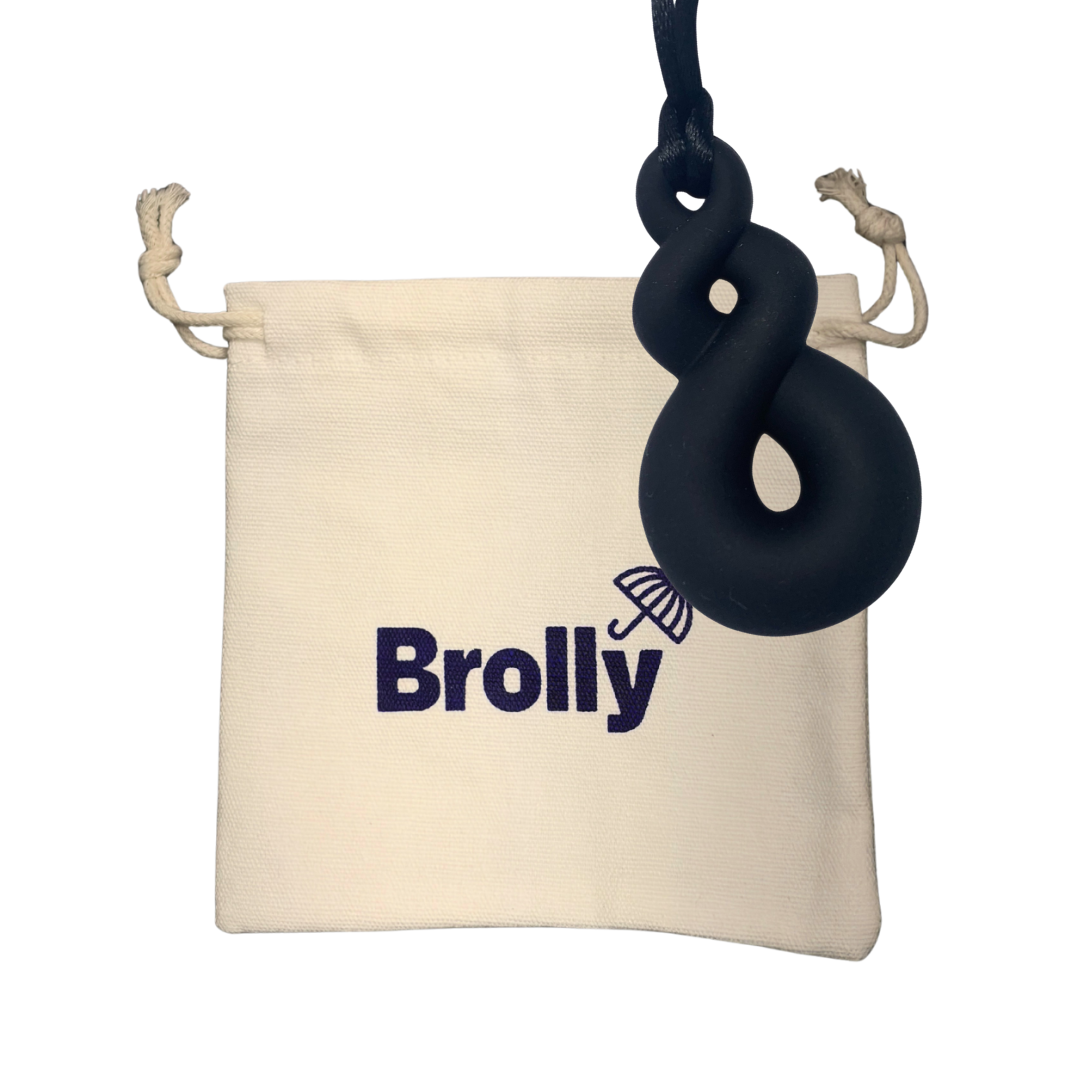 Beige drawstring pouch and Twist-shaped Brolly Sheet Chew Necklace on a black cord against a white background - Black