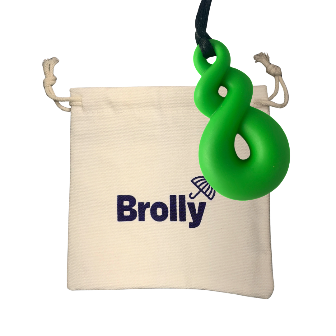 Beige drawstring pouch and Twist-shaped Brolly Sheet Chew Necklace on a black cord against a white background - Green