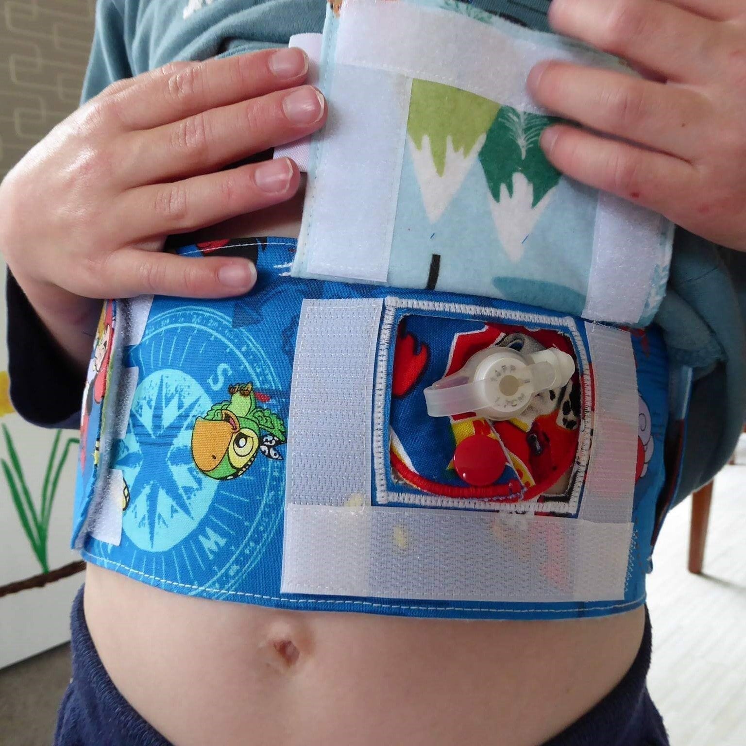 Child wearing a colorful feeding belt with cartoon designs