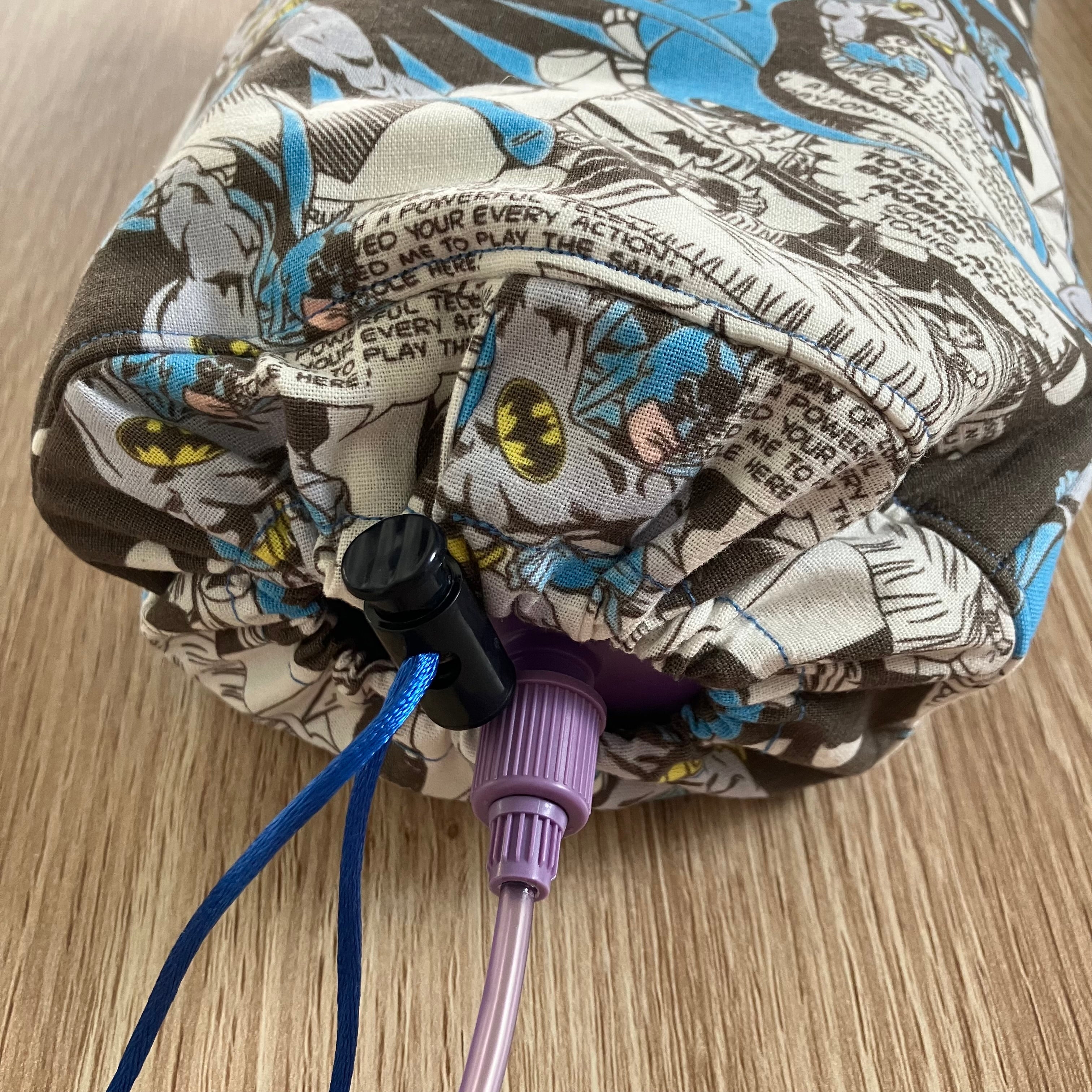 Comic book patterned insulated bottle cover with a bottle inside for demonstration