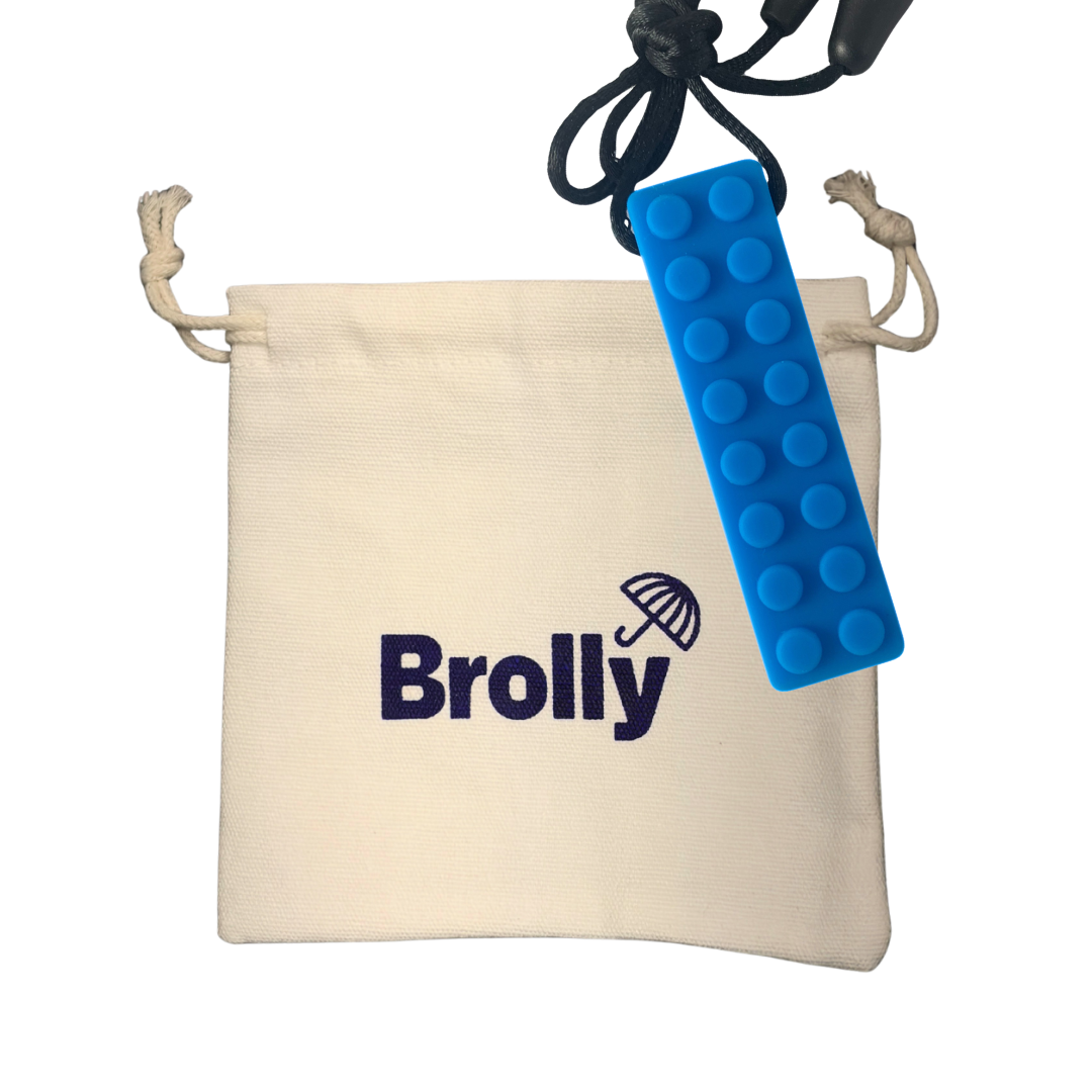 Beige drawstring pouch and Blue brick-shaped Brolly Sheet Chew Necklace on a black cord against a white background - Blue