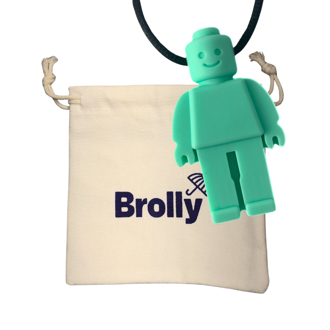 Beige drawstring pouch and Robot-shaped Brolly Sheet Chew Necklace on a black cord against a white background - Teal