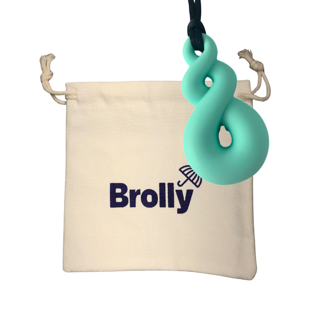 Beige drawstring pouch and Twist-shaped Brolly Sheet Chew Necklace on a black cord against a white background - Teal