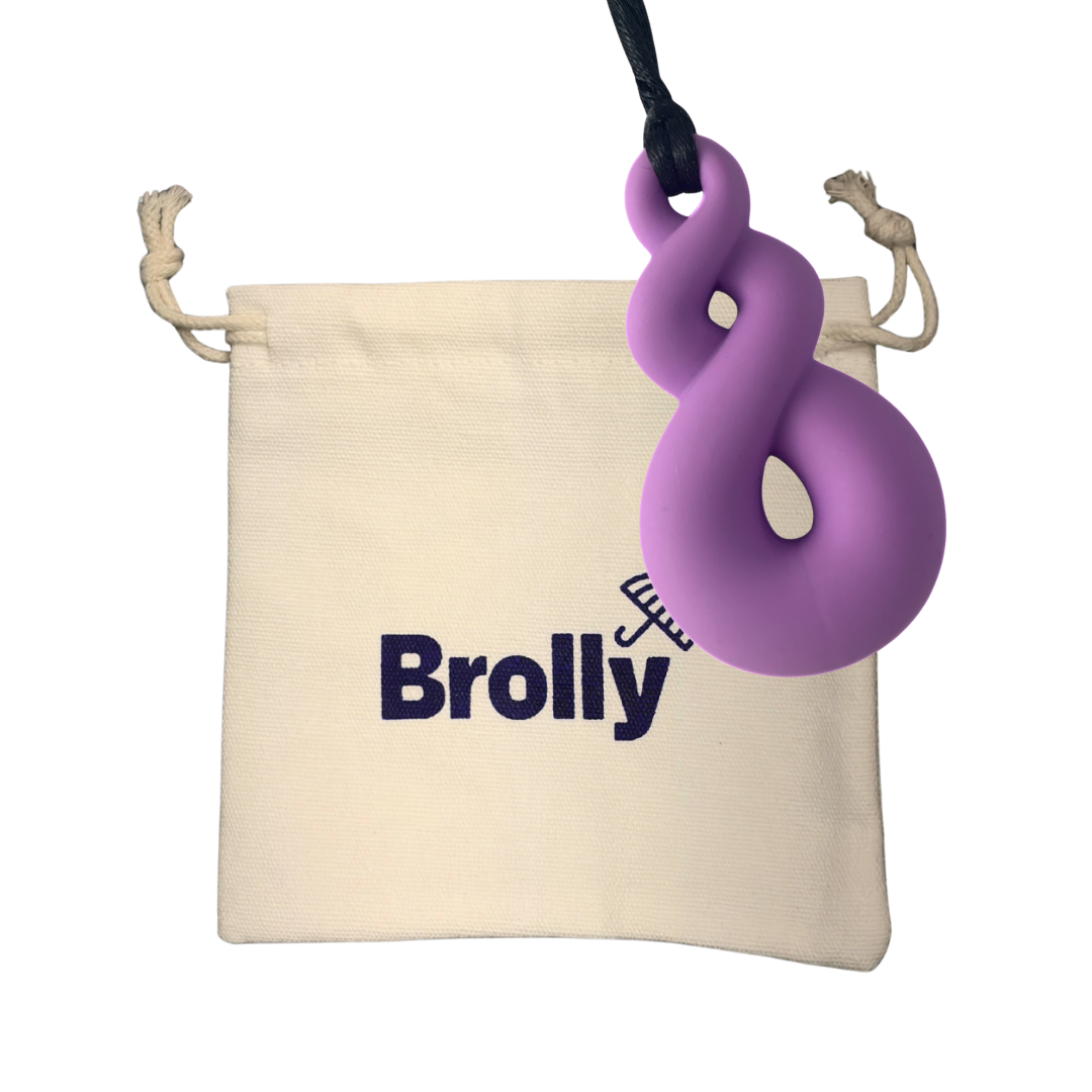 Beige drawstring pouch and Twist-shaped Brolly Sheet Chew Necklace on a black cord against a white background - Purple
