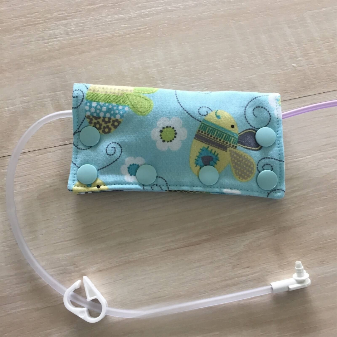 Connector cover / Port cover with clear tube on a wooden surface